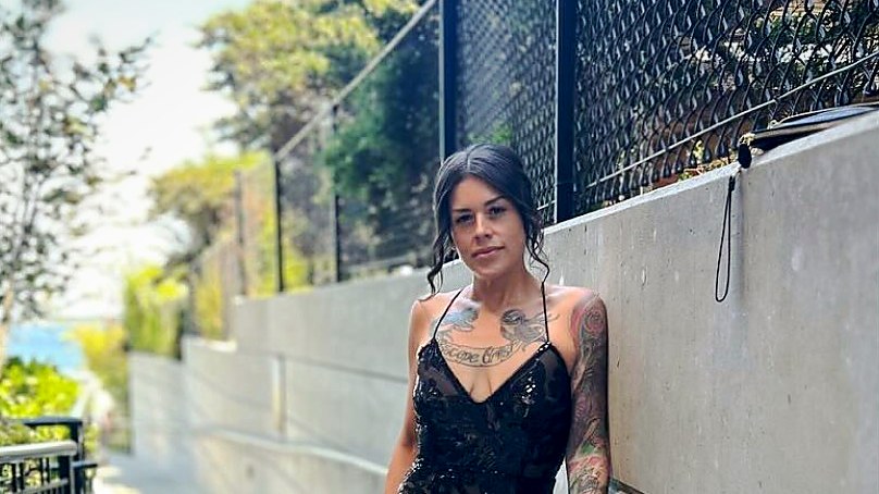 Sheena McCart standing in a sun-washed Vancouver walkway